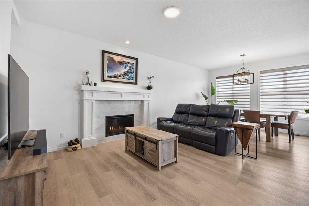 224 Precedence Hill, Cochrane, AB - Indoor Photo Showing Living Room With Fireplace