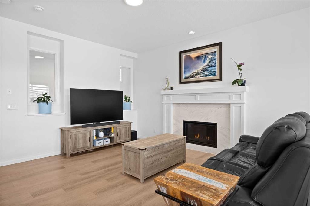 224 Precedence Hill, Cochrane, AB - Indoor Photo Showing Living Room With Fireplace