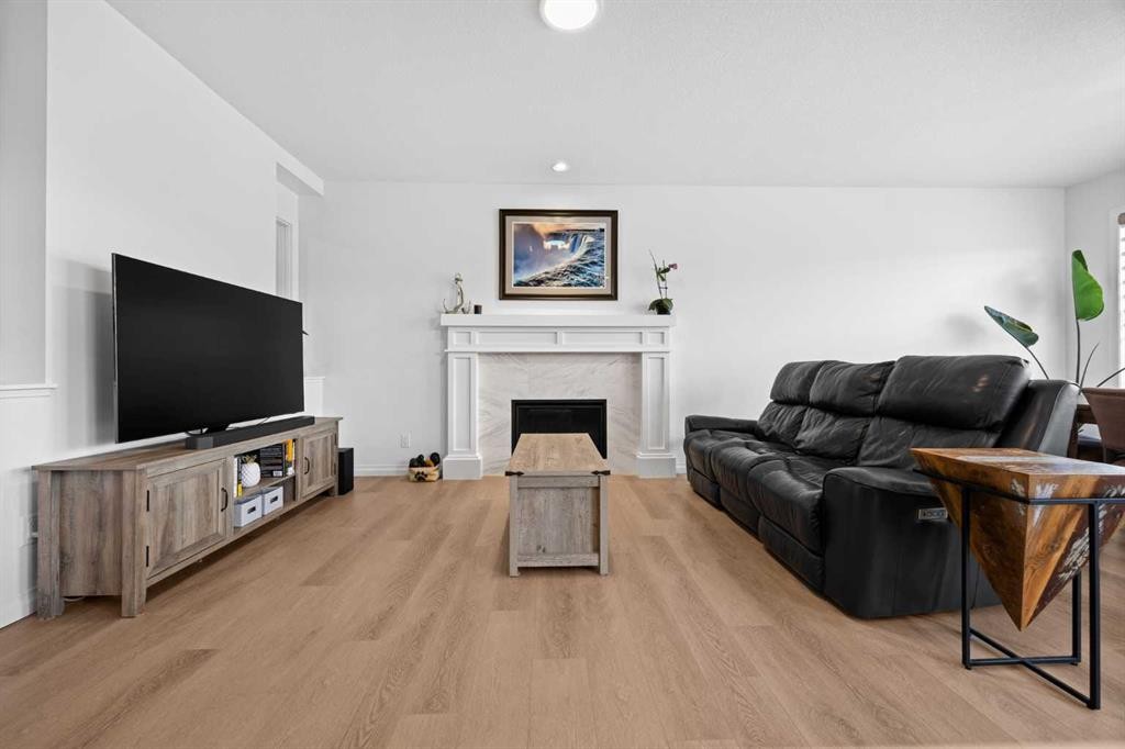 224 Precedence Hill, Cochrane, AB - Indoor Photo Showing Living Room With Fireplace