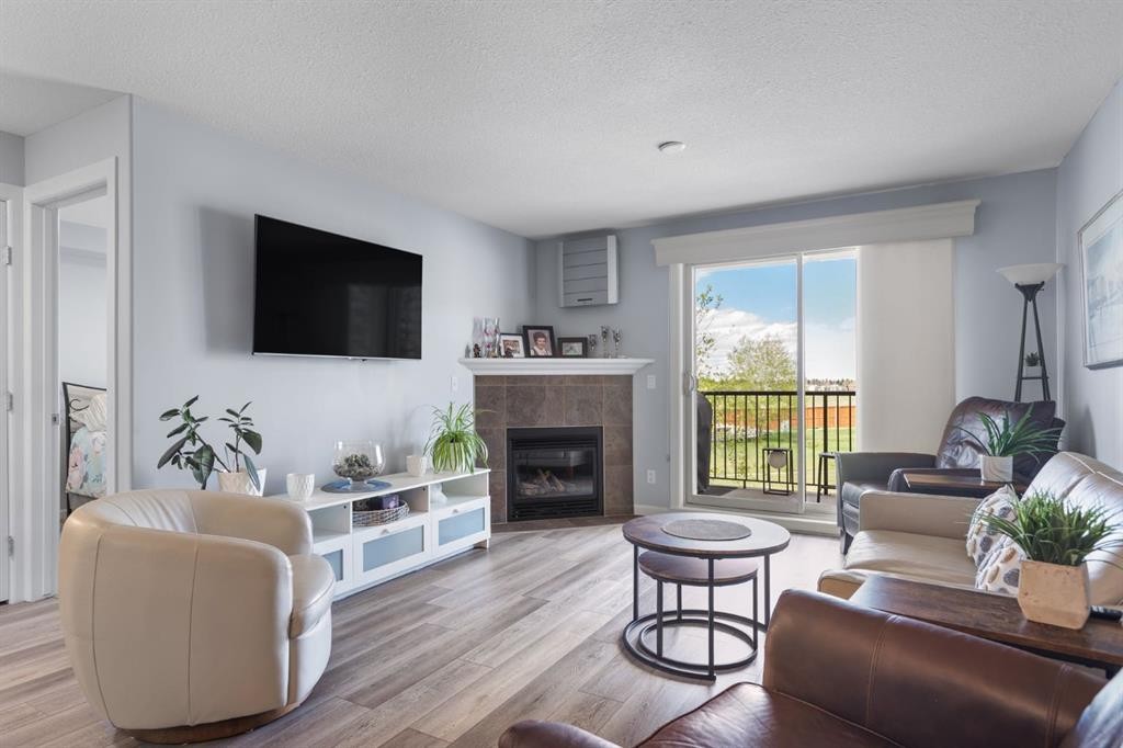 206-30 Cranfield Link Se, Calgary, AB - Indoor Photo Showing Living Room With Fireplace