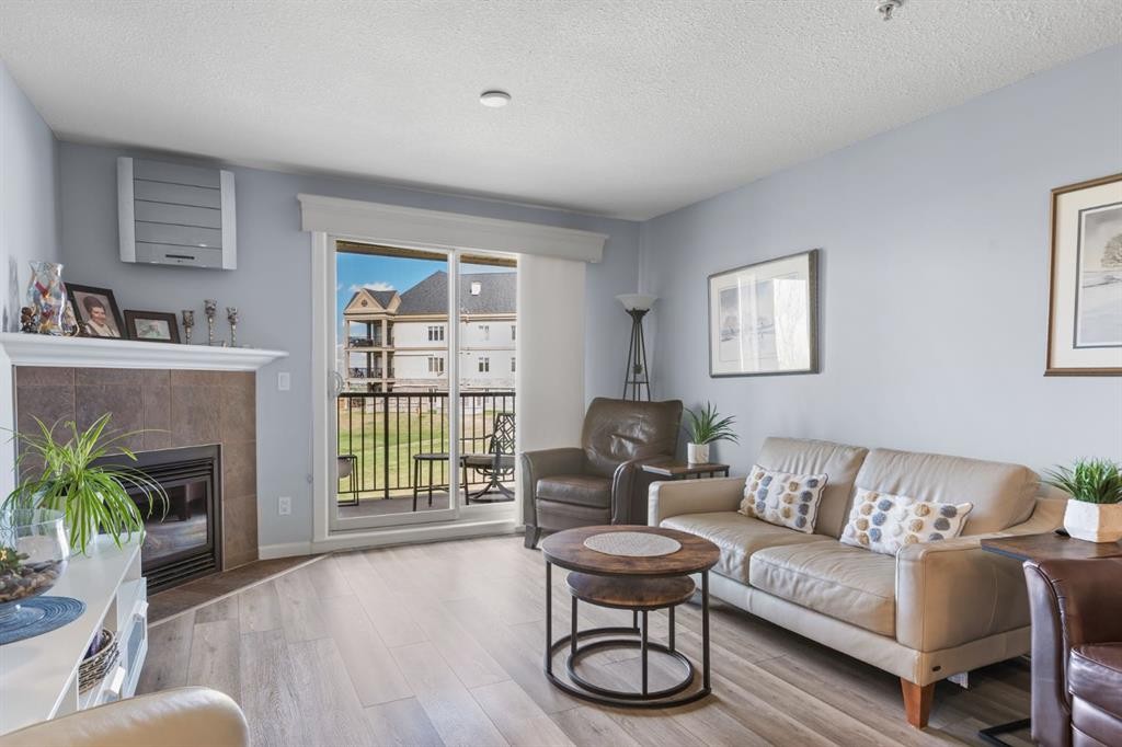 206-30 Cranfield Link Se, Calgary, AB - Indoor Photo Showing Living Room With Fireplace