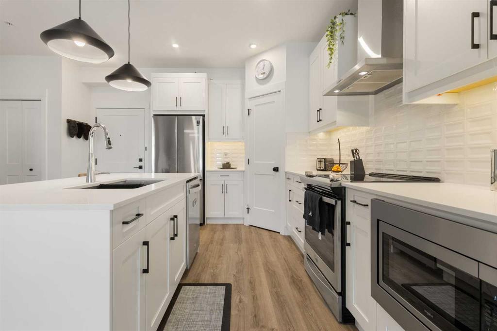 205-10 Sage Hill Walk Nw, Calgary, AB - Indoor Photo Showing Kitchen With Stainless Steel Kitchen With Upgraded Kitchen
