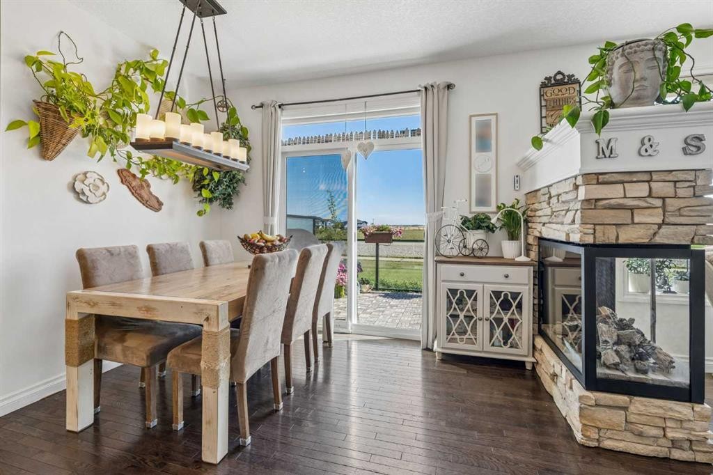 280 Rainbow Falls Way, Chestermere, AB - Indoor Photo Showing Dining Room With Fireplace