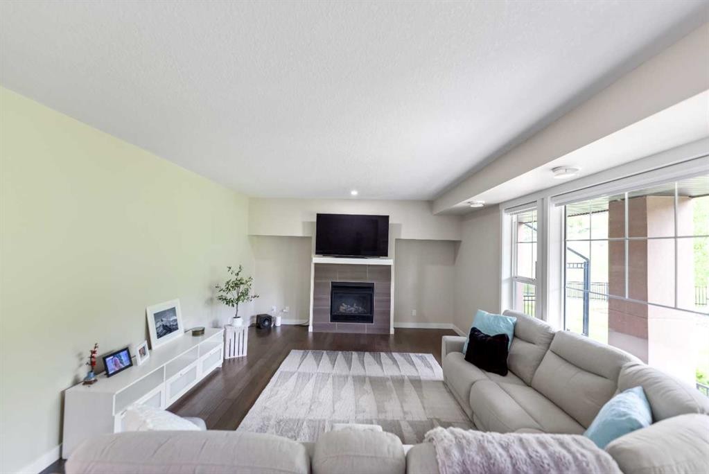 165 Cranbrook Villas Se, Calgary, AB - Indoor Photo Showing Living Room With Fireplace