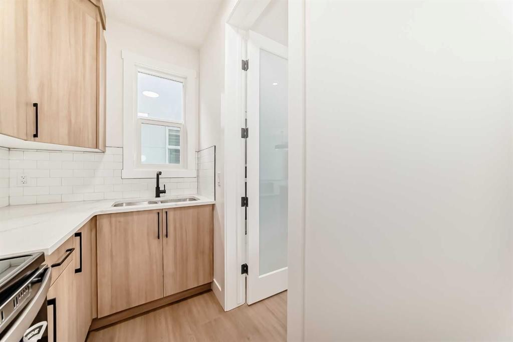 28 Saddlecrest Manor Ne, Calgary, AB - Indoor Photo Showing Kitchen With Double Sink