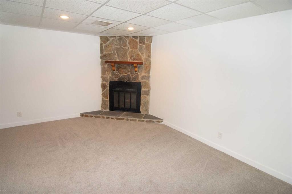 235 Avonburn Road Se, Calgary, AB - Indoor Photo Showing Other Room With Fireplace
