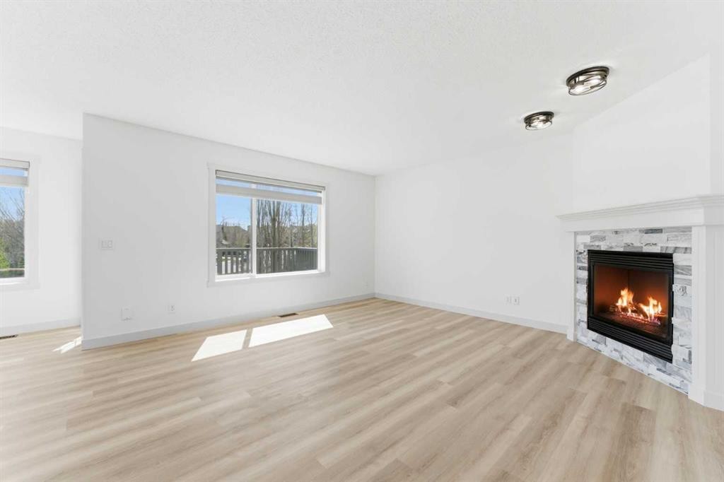 110 Tuscany Summit Green Nw, Calgary, AB - Indoor Photo Showing Living Room With Fireplace