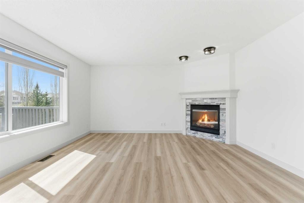 110 Tuscany Summit Green Nw, Calgary, AB - Indoor Photo Showing Living Room With Fireplace