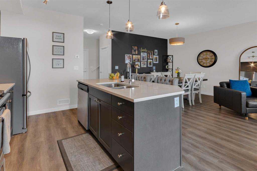 101-30 Shawnee Common Sw, Calgary, AB - Indoor Photo Showing Kitchen With Double Sink