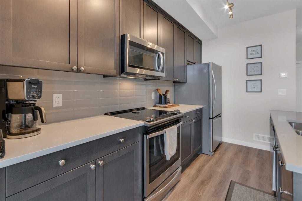 101-30 Shawnee Common Sw, Calgary, AB - Indoor Photo Showing Kitchen With Stainless Steel Kitchen With Upgraded Kitchen