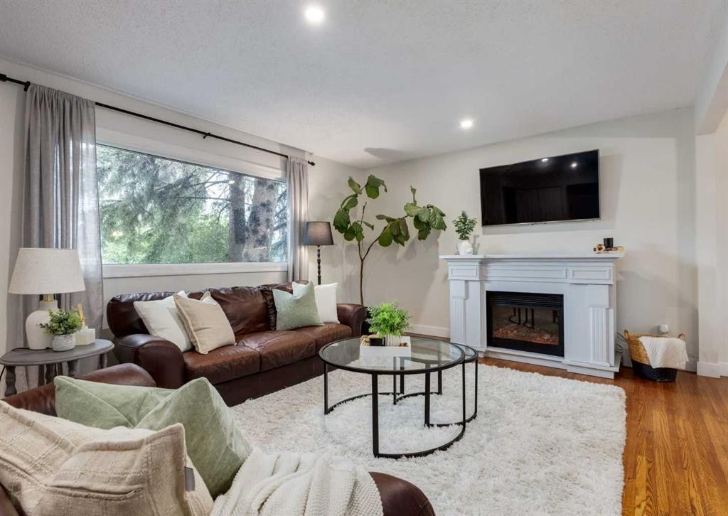 182 Fyffe Road Se, Calgary, AB - Indoor Photo Showing Living Room With Fireplace