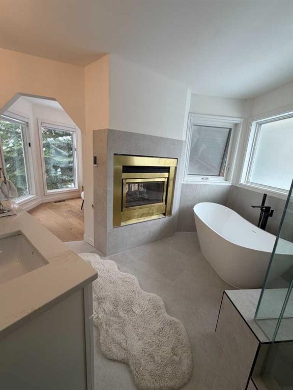 113 Straddock Terrace Sw, Calgary, AB - Indoor Photo Showing Living Room With Fireplace