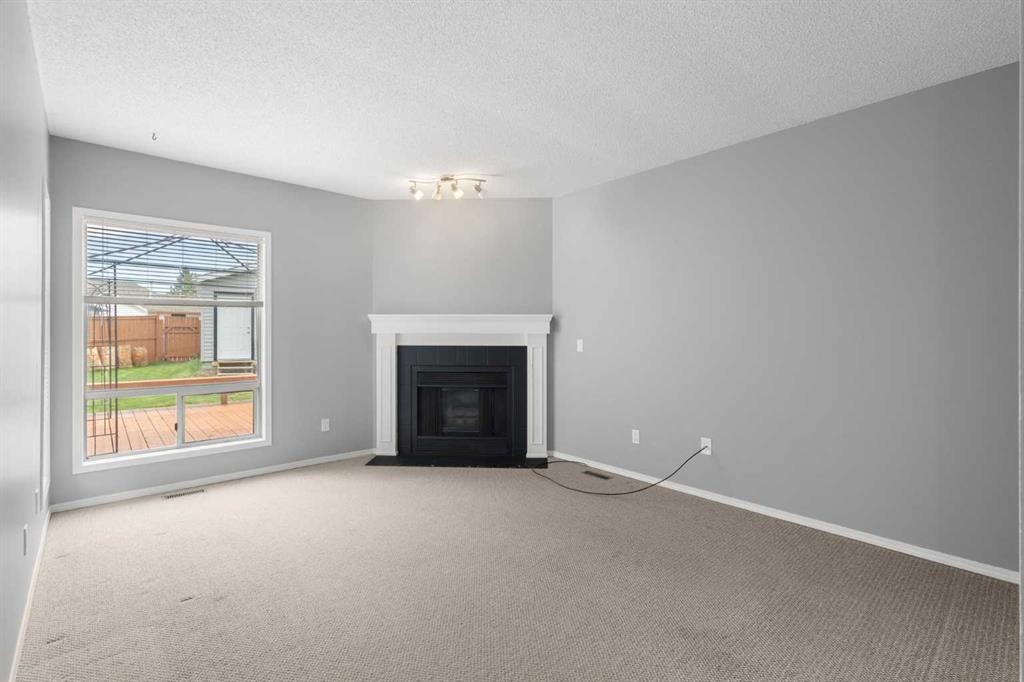256 Covington Place Ne, Calgary, AB - Indoor Photo Showing Living Room With Fireplace