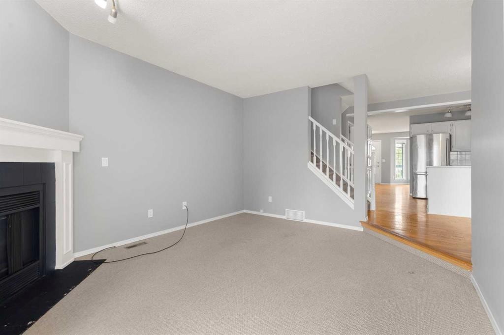 256 Covington Place Ne, Calgary, AB - Indoor Photo Showing Other Room With Fireplace