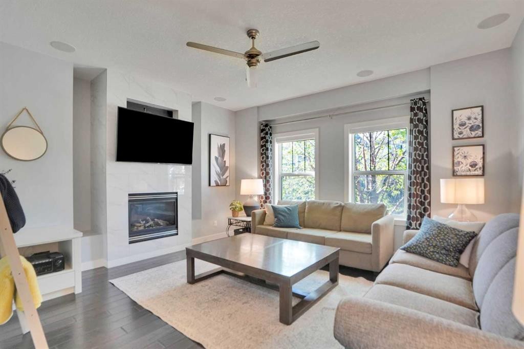 145 Marquis Common Se, Calgary, AB - Indoor Photo Showing Living Room With Fireplace