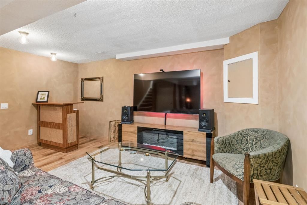 47 Cedargrove Way Sw, Calgary, AB - Indoor Photo Showing Living Room With Fireplace