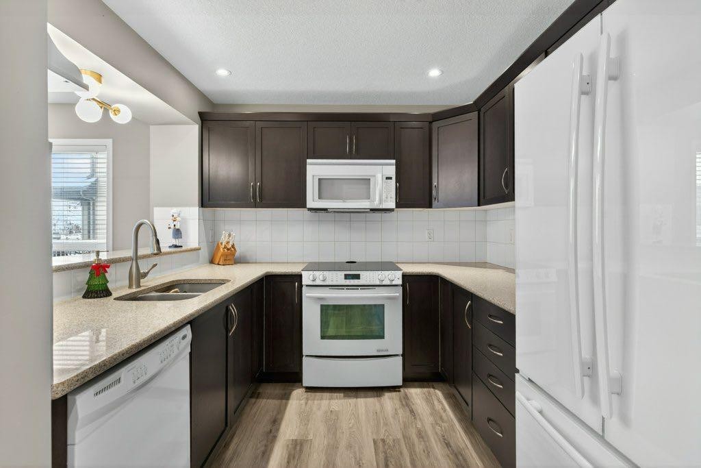 1012 Windsong Drive Sw, Airdrie, AB - Indoor Photo Showing Kitchen With Double Sink