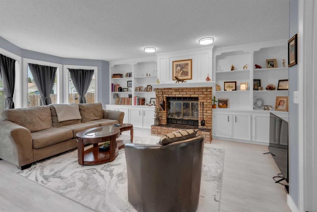 67 Deersaxon Circle Se, Calgary, AB - Indoor Photo Showing Living Room With Fireplace