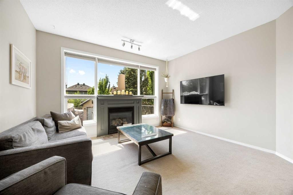 138 Cranwell Close Se, Calgary, AB - Indoor Photo Showing Living Room With Fireplace