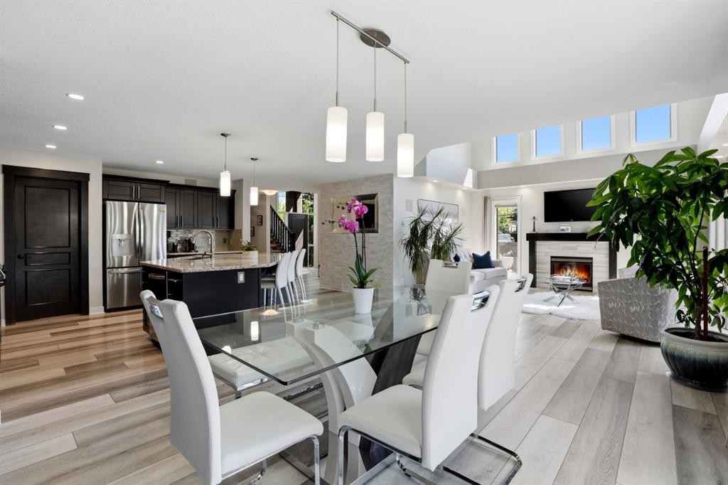 105 Cranridge Heights Se, Calgary, AB - Indoor Photo Showing Dining Room With Fireplace