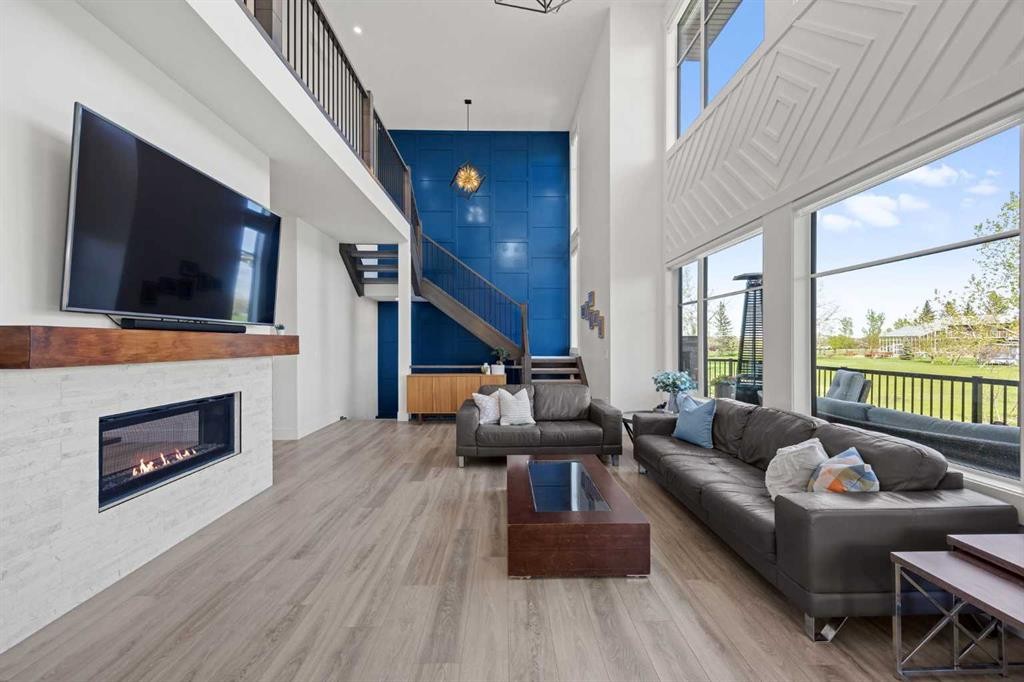 127 Kinniburgh Crescent, Chestermere, AB - Indoor Photo Showing Living Room With Fireplace