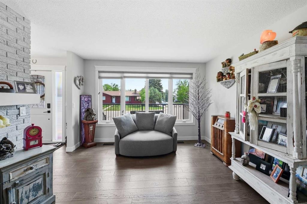 2406 26 Street, Nanton, AB - Indoor Photo Showing Living Room With Fireplace