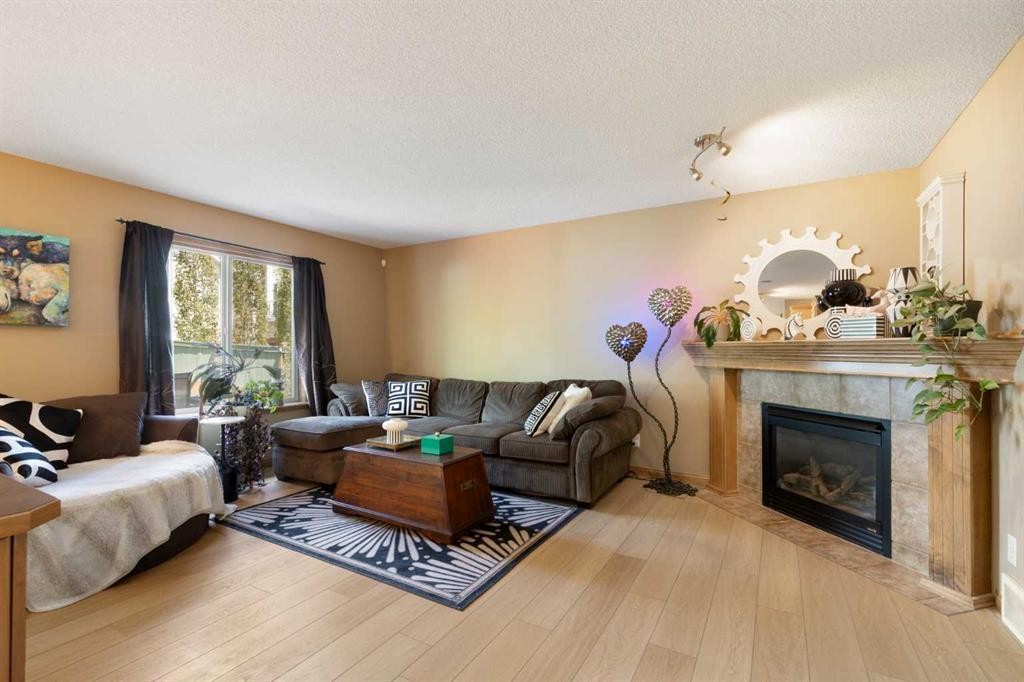 34 Tuscany Meadows Drive Nw, Calgary, AB - Indoor Photo Showing Living Room With Fireplace