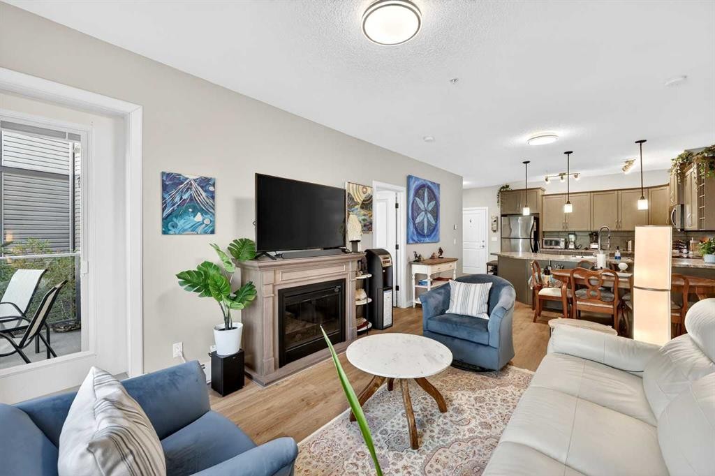 216-35 Aspenmont Heights Sw, Calgary, AB - Indoor Photo Showing Living Room With Fireplace