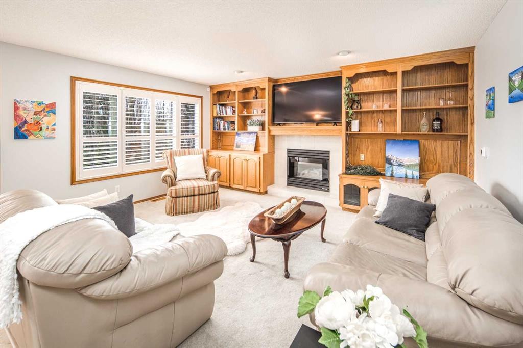 37 Arbour Summit Close Nw, Calgary, AB - Indoor Photo Showing Living Room With Fireplace