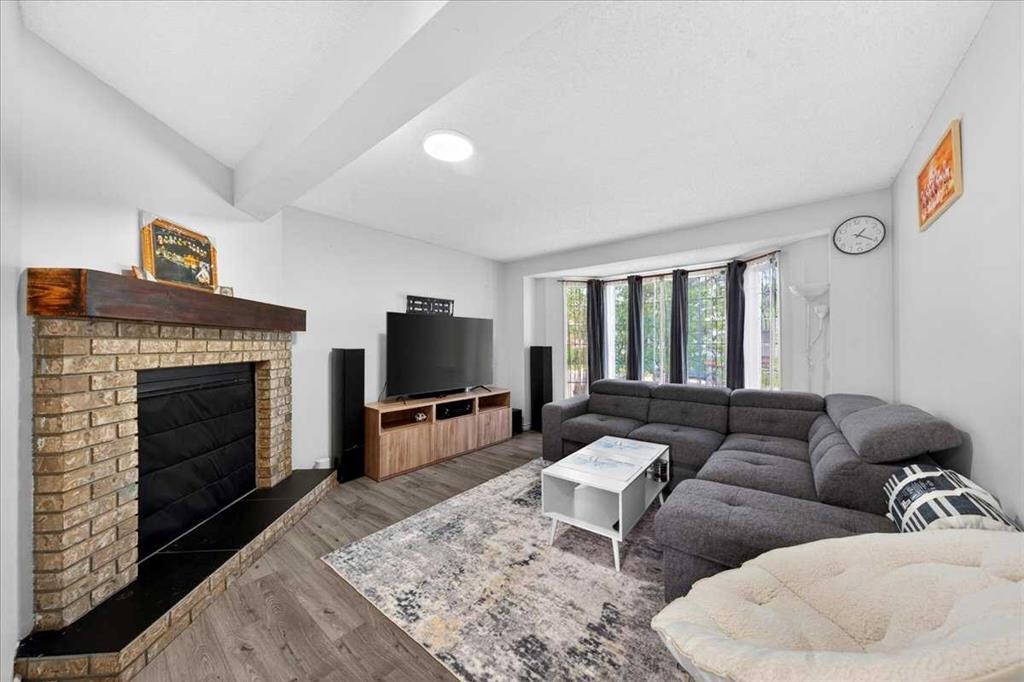 6979 Laguna Way Ne, Calgary, AB - Indoor Photo Showing Living Room With Fireplace