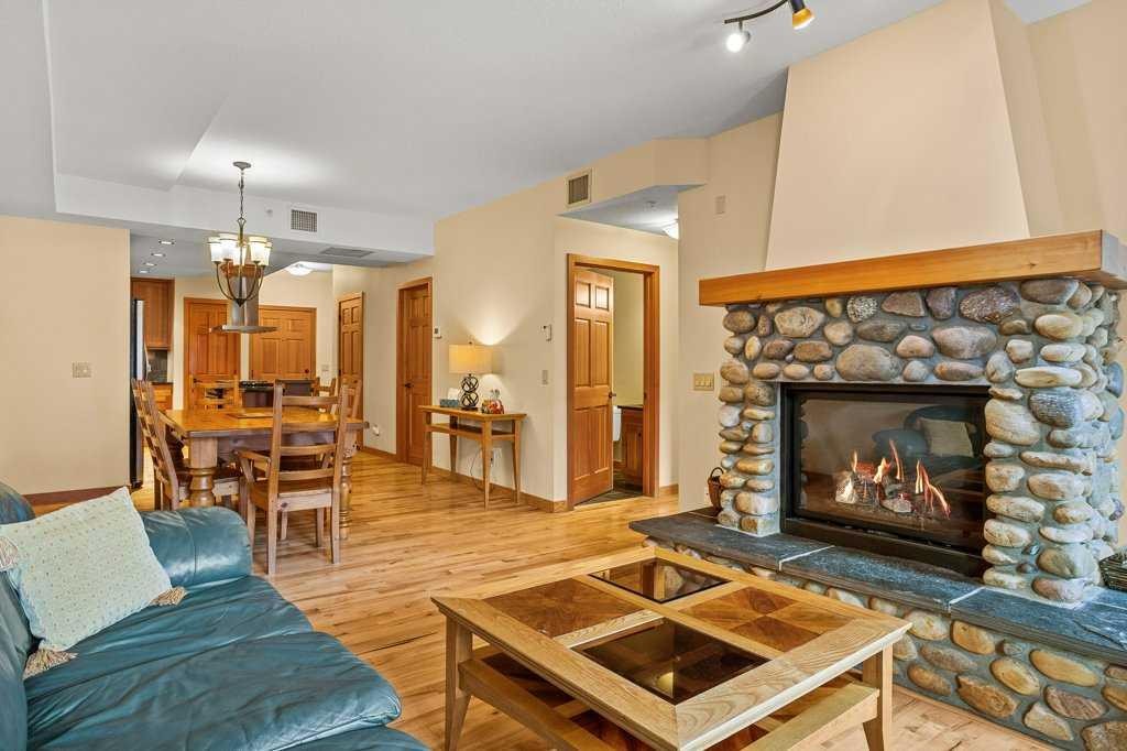 202-505 Spring Creek Drive, Canmore, AB - Indoor Photo Showing Living Room With Fireplace