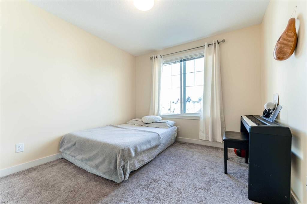 1402 Jumping Pound Common, Cochrane, AB - Indoor Photo Showing Bedroom