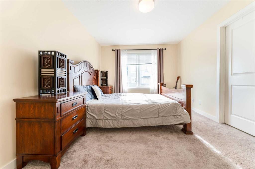 1402 Jumping Pound Common, Cochrane, AB - Indoor Photo Showing Bedroom