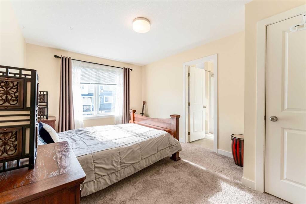 1402 Jumping Pound Common, Cochrane, AB - Indoor Photo Showing Bedroom