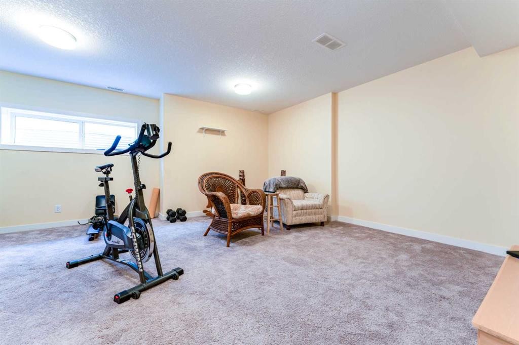1402 Jumping Pound Common, Cochrane, AB - Indoor Photo Showing Gym Room