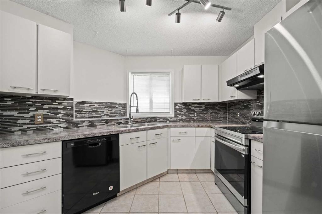 107 Tararidge Close Ne, Calgary, AB - Indoor Photo Showing Kitchen With Double Sink With Upgraded Kitchen