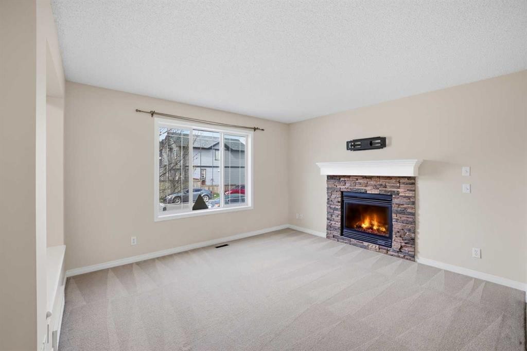 35 Saddlebrook Link Ne, Calgary, AB - Indoor Photo Showing Living Room With Fireplace