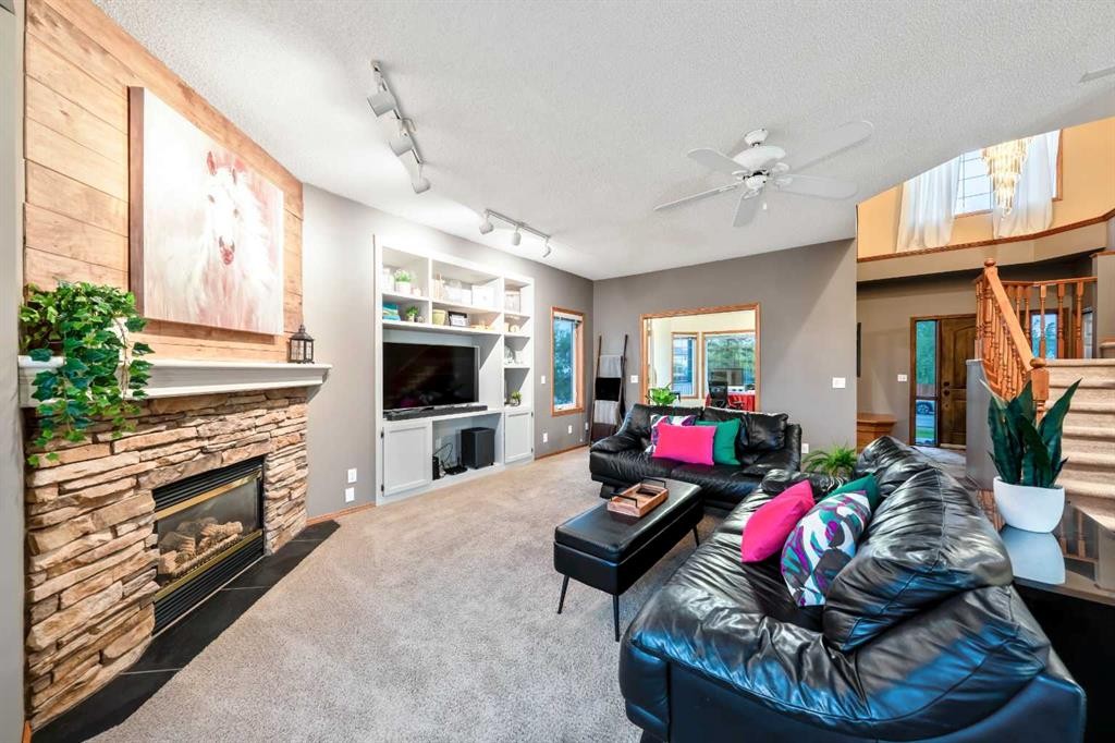 46 4 Street Ne, Langdon, AB - Indoor Photo Showing Living Room With Fireplace