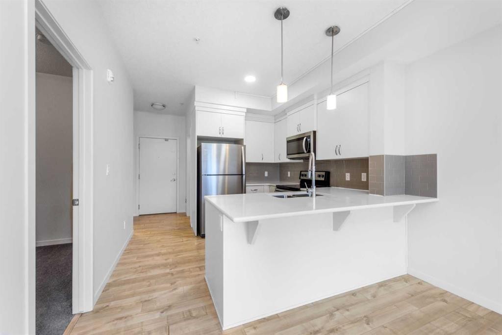 316-20 Seton Park Se, Calgary, AB - Indoor Photo Showing Kitchen With Stainless Steel Kitchen With Double Sink With Upgraded Kitchen