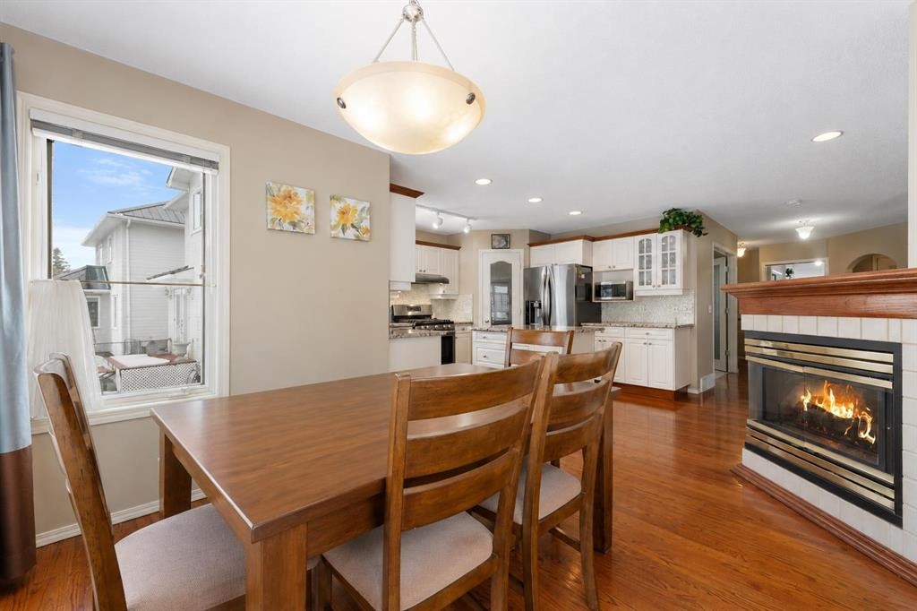 69 Hampstead Gardens Nw, Calgary, AB - Indoor Photo Showing Dining Room With Fireplace
