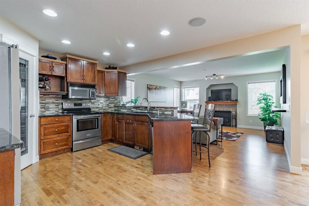 6 Cranwell Link Se, Calgary, AB - Indoor Photo Showing Kitchen With Fireplace