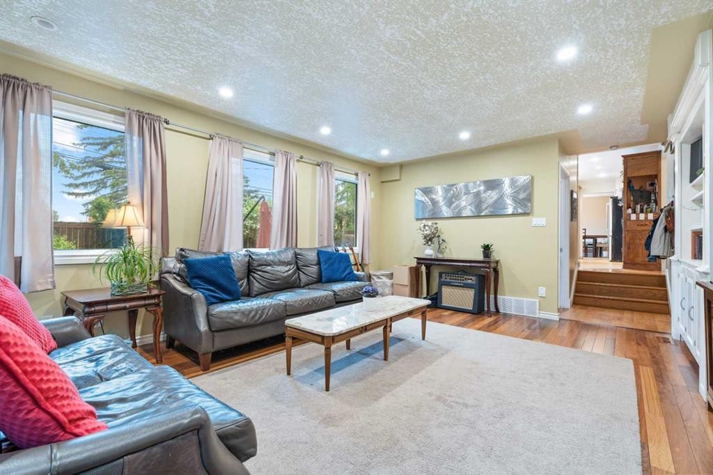 411 Wilderness Place Se, Calgary, AB - Indoor Photo Showing Living Room With Fireplace