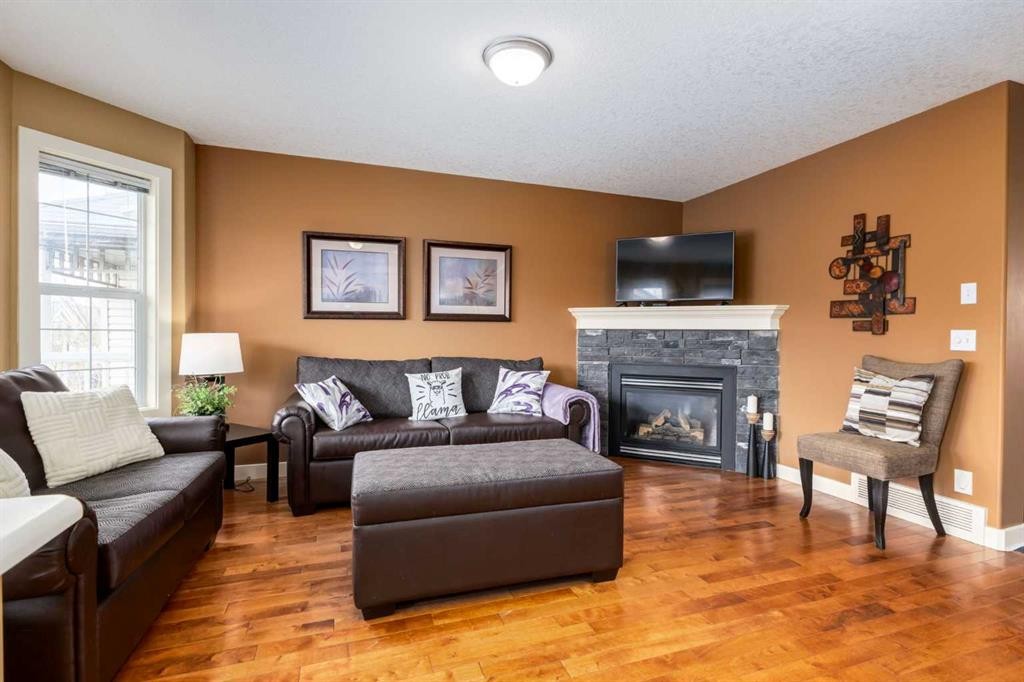 159 Cimarron Grove Crescent, Okotoks, AB - Indoor Photo Showing Living Room With Fireplace