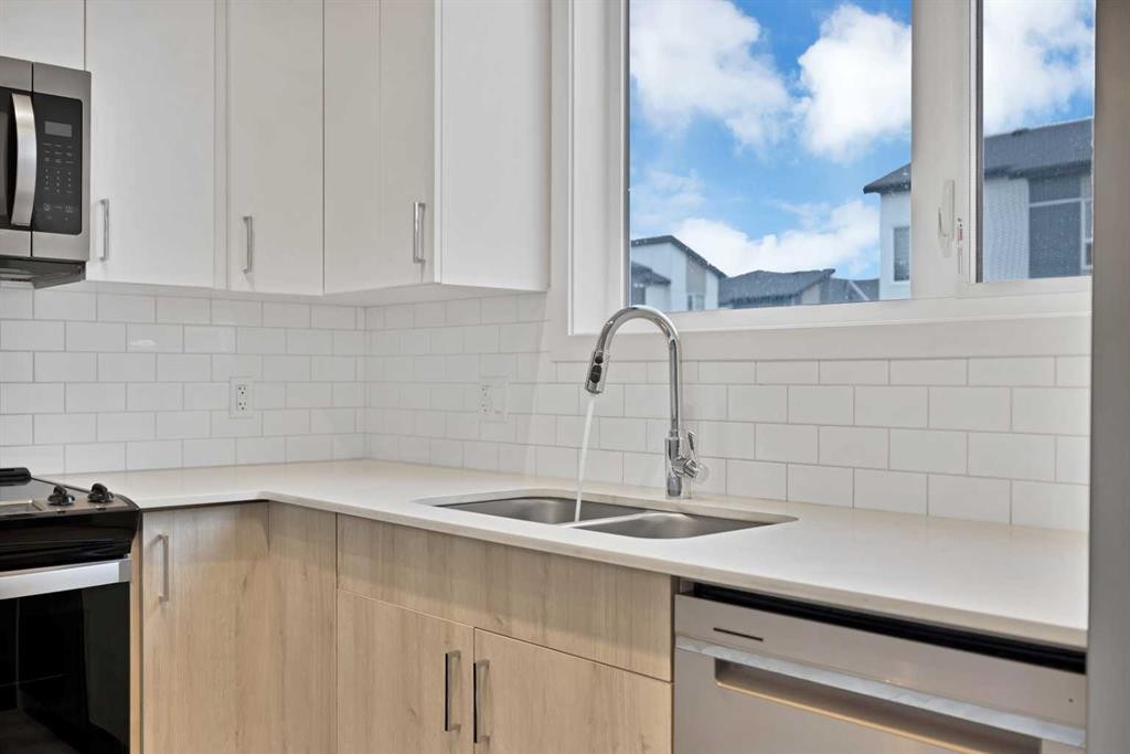 411-301 Redstone Boulevard Ne, Calgary, AB - Indoor Photo Showing Kitchen With Double Sink