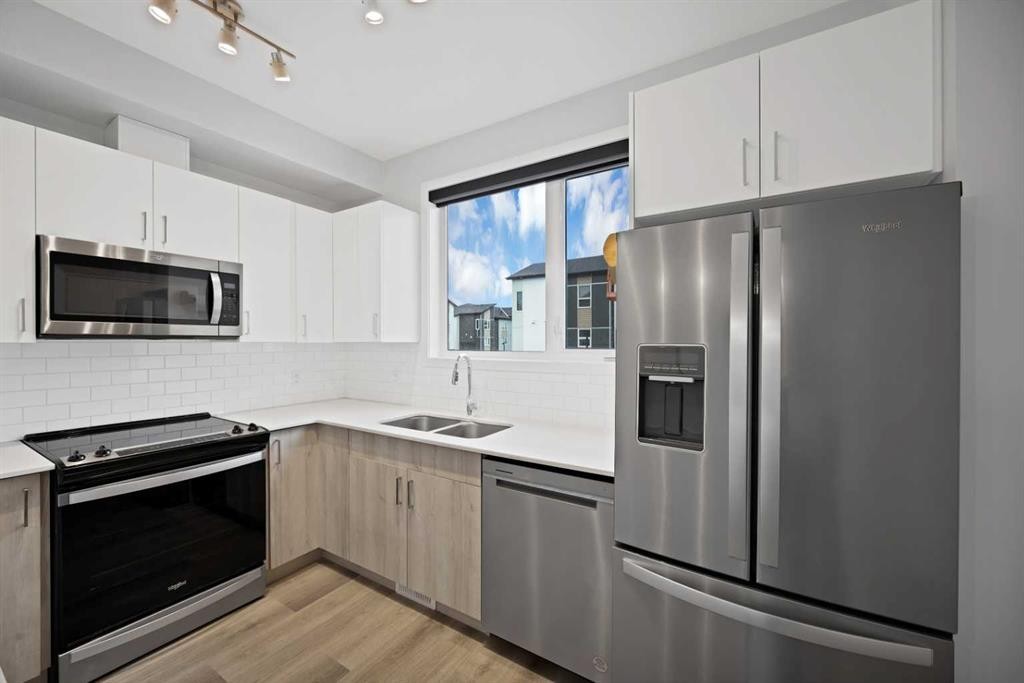 411-301 Redstone Boulevard Ne, Calgary, AB - Indoor Photo Showing Kitchen With Stainless Steel Kitchen With Double Sink