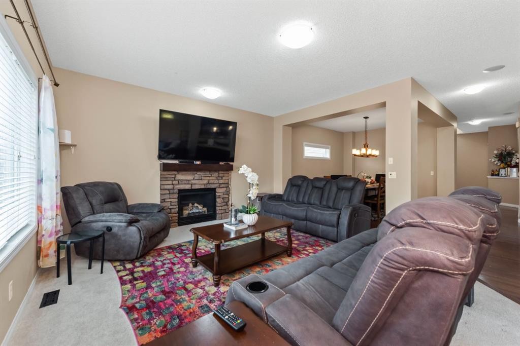 203 Morningside Circle Sw, Airdrie, AB - Indoor Photo Showing Living Room With Fireplace