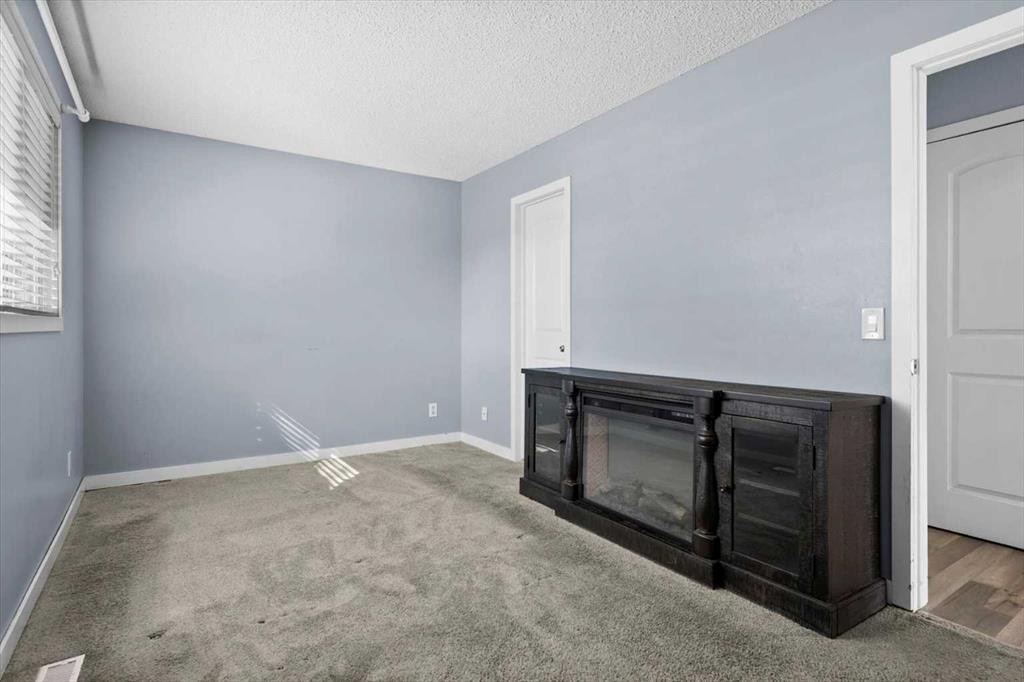 72 Marquis Place Se, Airdrie, AB - Indoor Photo Showing Other Room With Fireplace