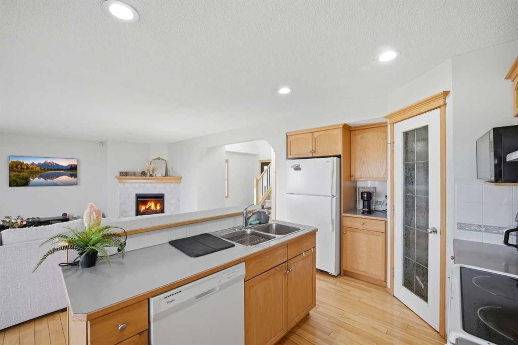 101 Coville Crescent Ne, Calgary, AB - Indoor Photo Showing Kitchen With Fireplace With Double Sink
