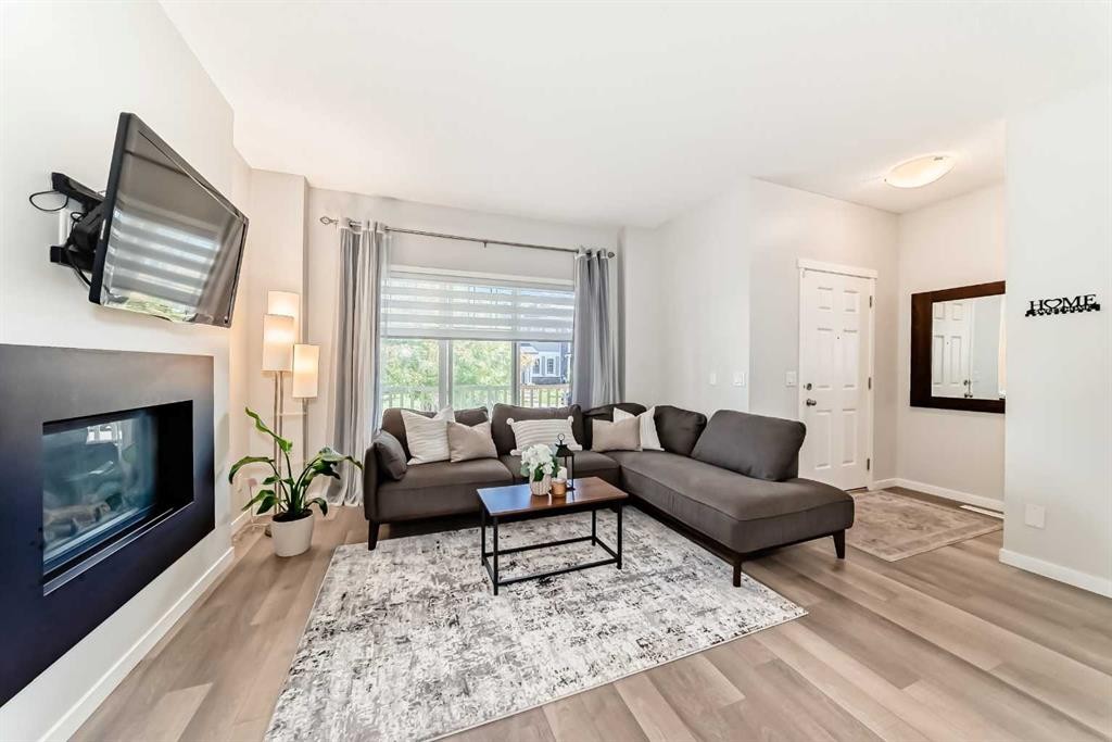 151 Copperpond Rise Se, Calgary, AB - Indoor Photo Showing Living Room With Fireplace