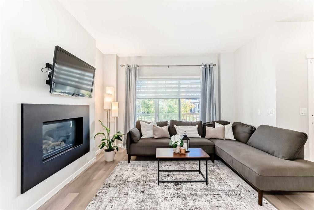 151 Copperpond Rise Se, Calgary, AB - Indoor Photo Showing Living Room With Fireplace